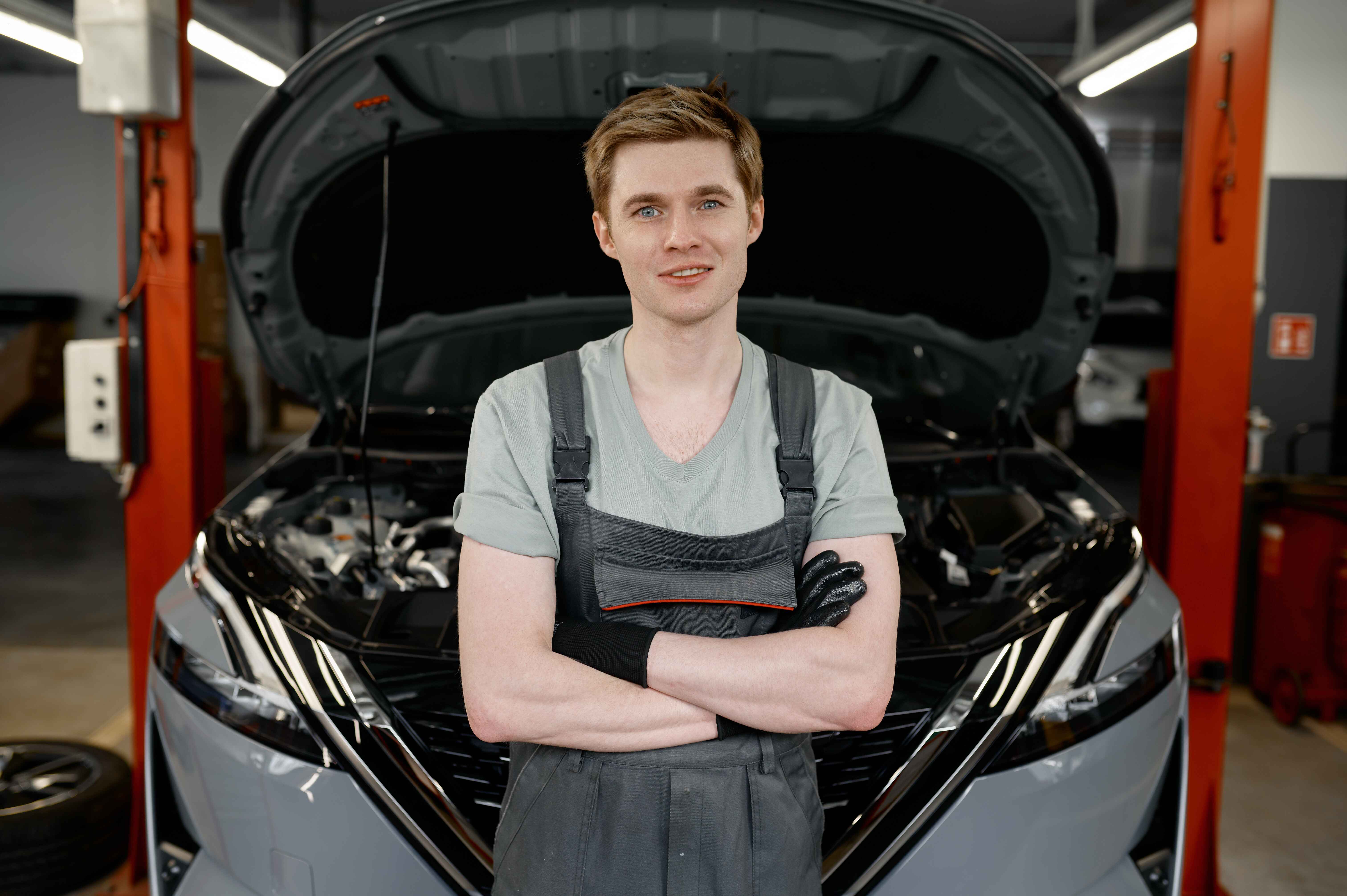 portrait-of-professional-young-male-car-mechanic-graduating-UTI-college-auto-repair-Ontario-CA